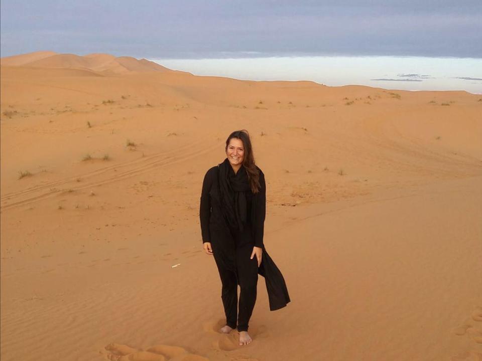 A woman posing in the desert.