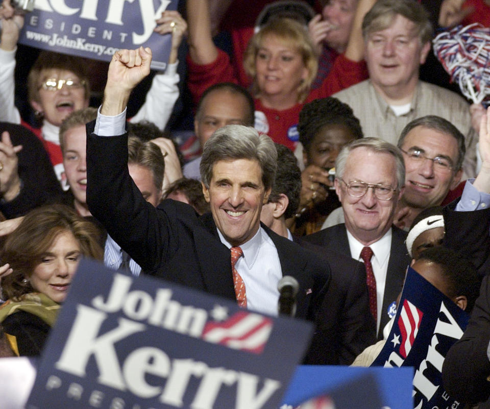 FILE - Presidential hopeful Sen. John Kerry acknowledges the crowd at a victory party Monday, Jan. 19, 2004, in Des Moines, Iowa after Kerry was declared the winner of the Iowa Caucus. (AP Photo/M. Spencer Green, File)