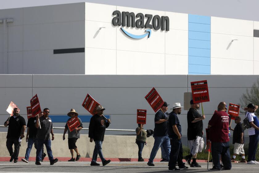 San Bernardino, CA - October 14: Amazon warehouse workers and members of Teamsters Union protest Amazon's unfair labor practices and shameful response to workers' demands for better, safer jobs with fair wages and an end to retaliation at Amazon Air Hub on Friday, Oct. 14, 2022 in San Bernardino, CA. (Irfan Khan / Los Angeles Times)