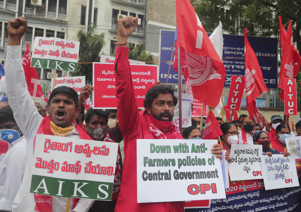 Members of All India Kisan Sangharsh Coordination Committee (AIKSCC) and activists of left parties and trade unions participate in a nationwide protest in Hyderabad, India, Friday, Sept. 25, 2020. Hundreds of Indian farmers took to the streets on Friday protesting new laws that the government says will boost growth in the farming sector through private investments, but they fear these are likely to be exploited by private players for buying their crops cheaply. (AP Photo/Mahesh Kumar A.)