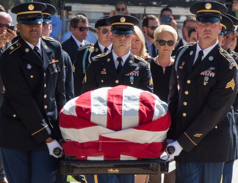 Members of the Arizona National Guard carry John McCain&rsquo;s casket to the state Capitol Rotunda, followed by Cindy McCain, Aug. 29. (Photo: ROBYN BECK / Getty Images)