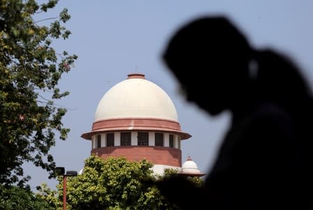 A woman checks her mobile phone inside the premises of the Supreme Court in New Delhi