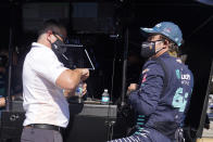 Fernando Alonso, of Spain, talks with Gil de Ferran following a practice session for the Indianapolis 500 auto race at Indianapolis Motor Speedway, Friday, Aug. 14, 2020, in Indianapolis. (AP Photo/Darron Cummings)