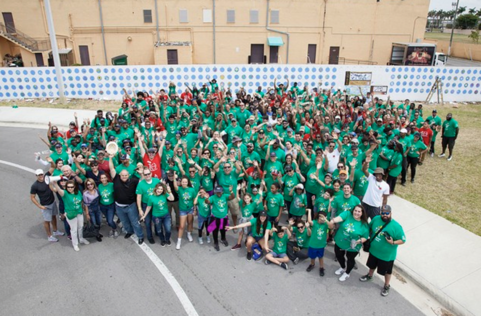 Xavier Cortada and more than 300 volunteers in Sweetwater celebrate a new mural that was painted on Sweetwater Elementary in May 2018.