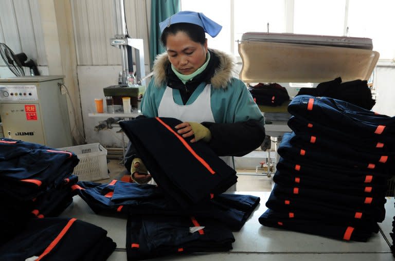A woman works in a clothing factory in Huaibei, central China's Anhui province, January 10, 2013. China grew at its slowest pace in 13 years in 2012, with gross domestic product expanding 7.8 percent in the face of weakness at home and in key overseas markets