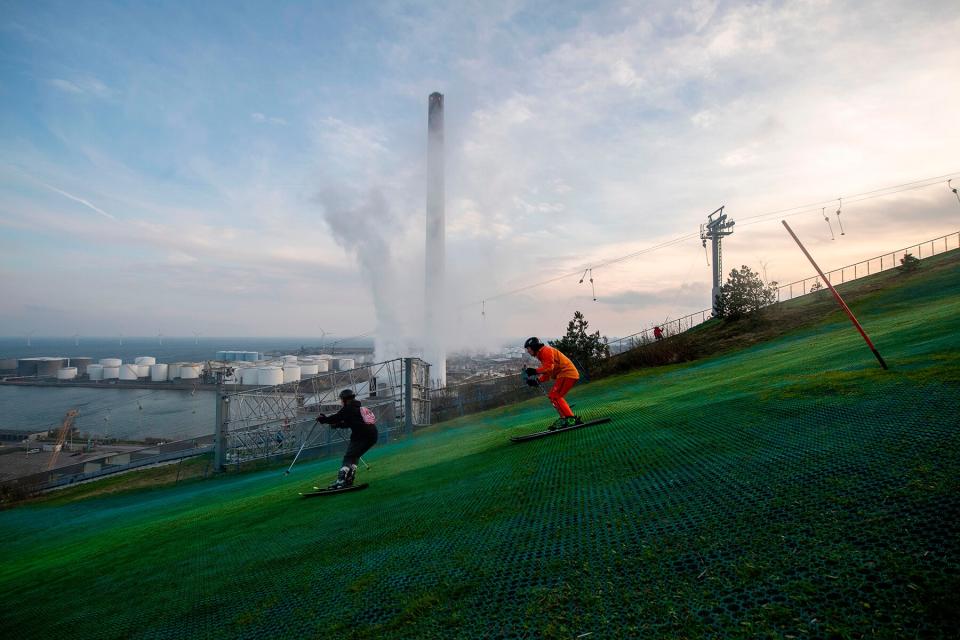 People ski down the artificial ski hill on the outdoor structure CopenHill in Copenhagen