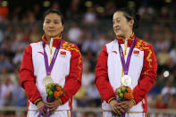 LONDON, ENGLAND - AUGUST 02: Silver medalists Jinjie Gong (L) and Shuang Guo of China celebrate with their silver medals during the medal ceremony for the Women's Team Sprint Track Cycling on Day 6 of the London 2012 Olympic Games at Velodrome on August 2, 2012 in London, England. (Photo by Bryn Lennon/Getty Images)