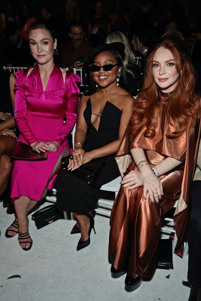 (L-R) Julia Stiles, Quinta Brunson and Lindsay Lohan attend Christian Siriano’s fall 2023 fashion show during New York Fashion Week at Gotham Hall in New York City on Feb. 9, 2023. - Credit: Jamie McCarthy/Getty Images for Christian Siriano