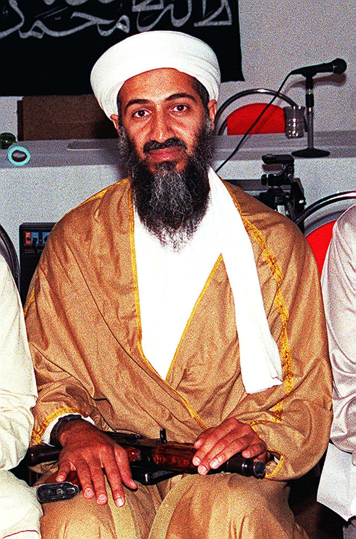 AFGHANISTAN:An undated file picture shows Osama Bin Laden attending a meeting with a Kalashnikov on his lap in an undisclosed place inside Afghanistan. Bin Laden is reported to have been funding the Abu Sayyaf, who are currently holding over a dozen hostages in the southern Philippine island of Jolo, through a Islamic charity, the International Islamic Relief Organisation (IIRO) which he set up in 1992 with his brother-in-law Mohammad Jamal Khalifa as a front for funding extremist groups. Bin Laden, a wealthy Saudi dissident living in Afghanistan, is wanted by the United States for masterminding a terrorist attack on tow US embassies in east Africa in 1998 which killed 224 people. AFP PHOTO/FILES (Photo credit should read AFP via Getty Images)