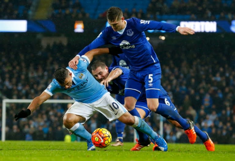 Everton defender John Stones (R) vies with Manchester City's striker Sergio Aguero during the English Premier League match in Manchester, north-west England on January 13, 2016