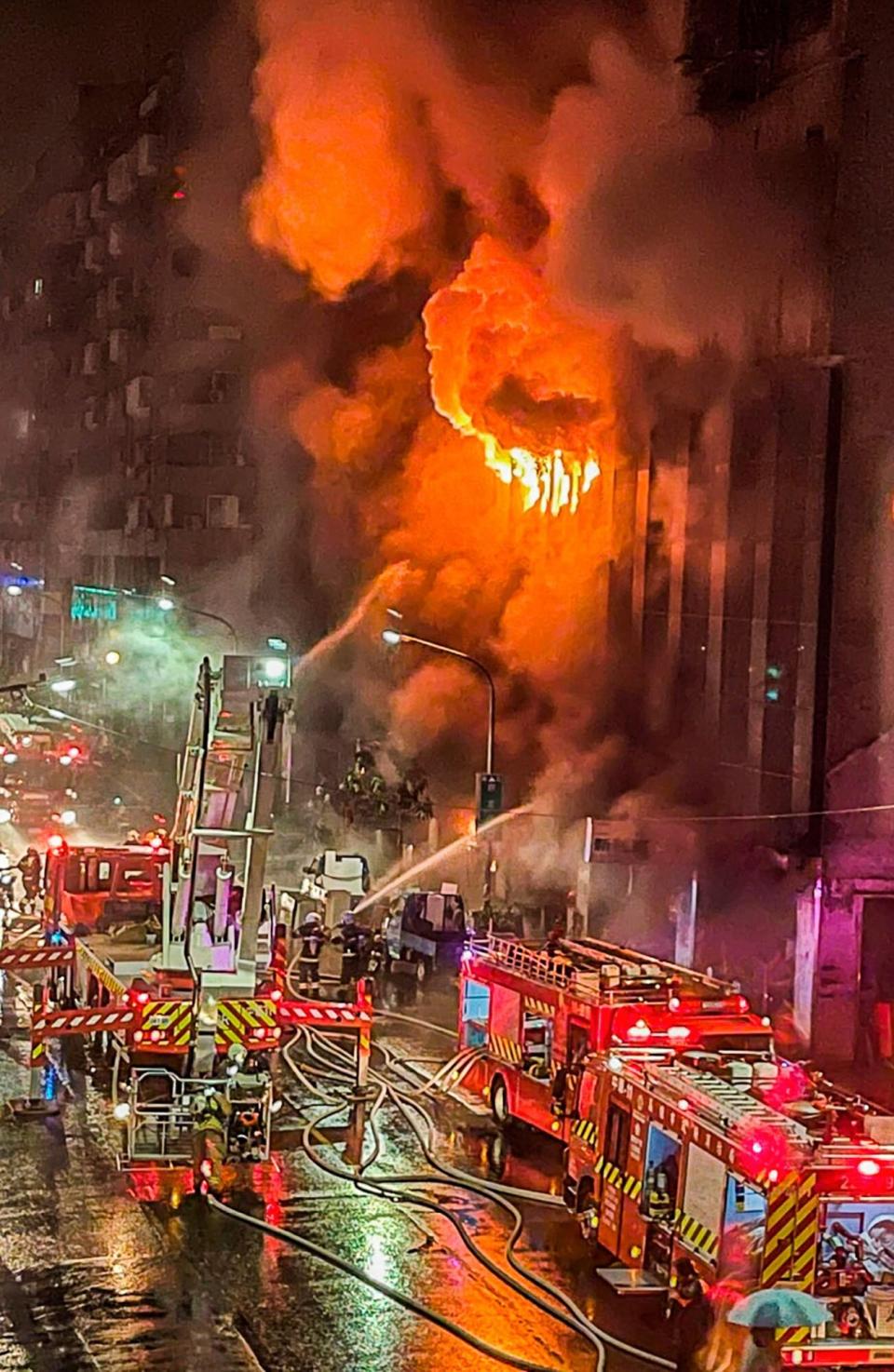 Firefighters battle a building fire in Kaohsiung