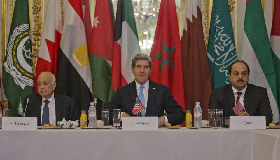 US Secretary of State, John Kerry, center, with Arab League Secretary General Nabil Elaraby, left, and Qatar's Foreign Minister Khalid bin Mohamed Al-Attiyah, right, before the start of a meeting with representatives of the Arab League at the US Ambassador's residence in Paris, France, Sunday, Jan. 12, 2014. Kerry is in Paris to attend a two-day meeting on Syria to rally international support for ending the three-year civil war. (AP Photo/Pablo Martinez Monsivais, Pool)