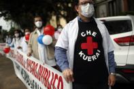 Doctors protest for better working conditions and resources to fight the COVID-19 pandemic in Asuncion, Paraguay, Friday, May 14, 2021. (AP Photo/Jorge Saenz)