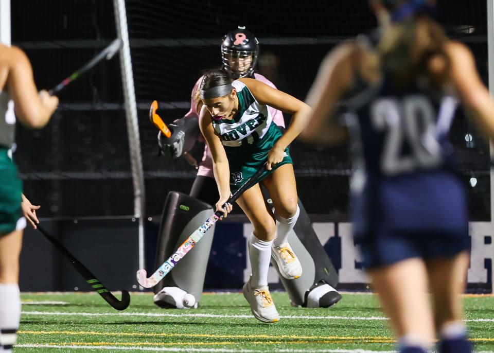 Dover's Aaliyah Stancil (11) stops the ball during Tuesday's Division I field hockey semifinal.