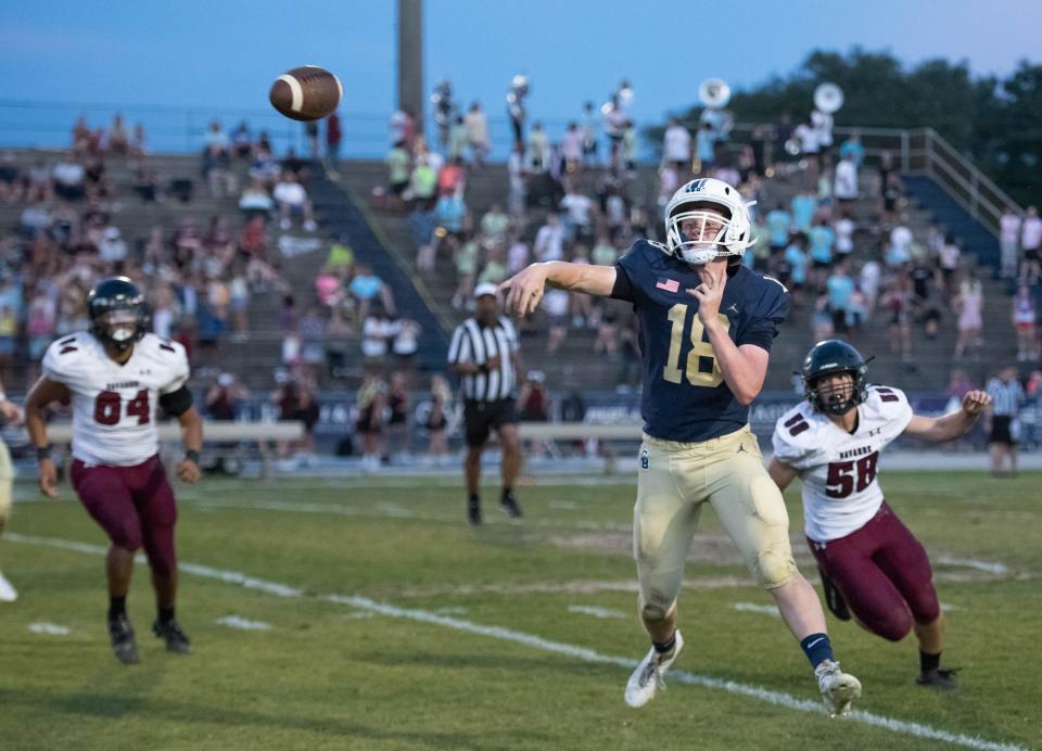 Quarterback Battle Alberson (18) throws the ball away during the Navarre vs Gulf Breeze spring football game at Gulf Breeze High School on Friday, May 19, 2023.