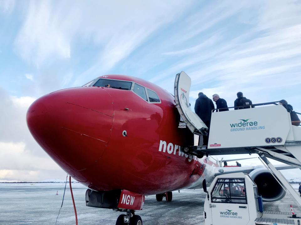 FILE PHOTO: Passengers board a Norwegian Air plane in Kirkenes, Norway October 26, 2019. Picture taken October 26, 2019. REUTERS/Gwladys Fouche