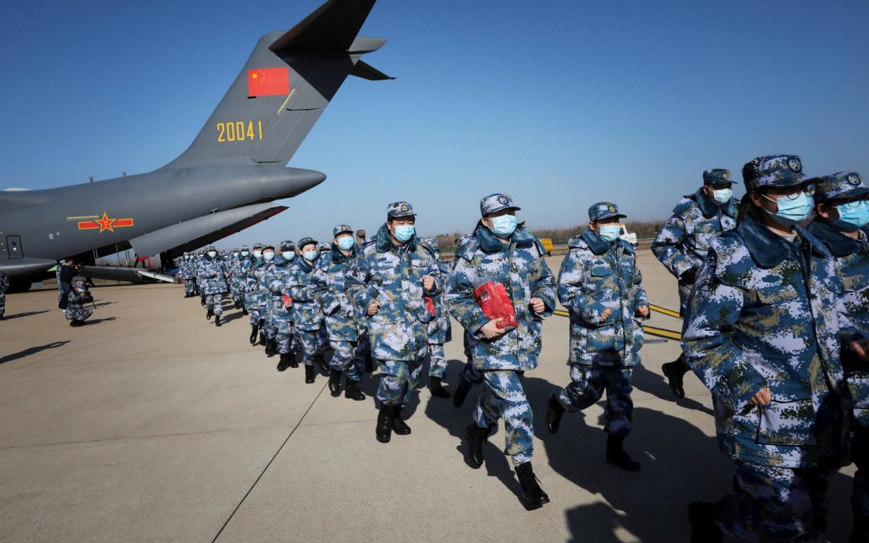 Medical personnel arrive in transport aircraft of the Chinese People's Liberation Army (PLA) Air Force at the Wuhan Tianhe International Airport following the outbreak of Covid-19 in Wuhan, Hubei province, China February 17, 2020.  - China Daily CDIC/REUTERS
