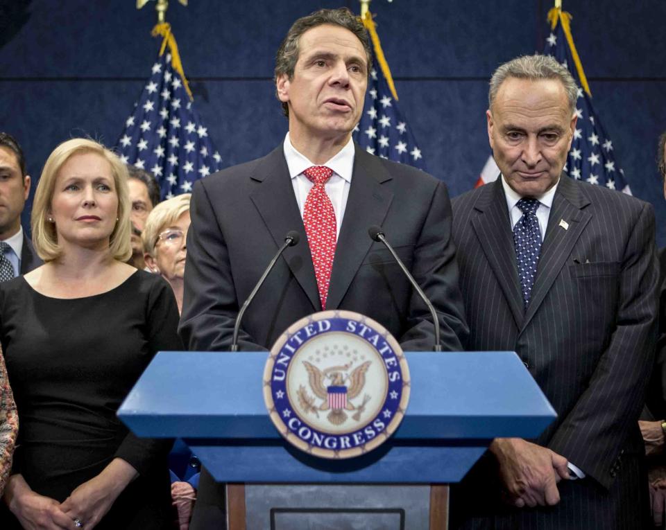 FILE - In this Dec. 3, 2012, file photo, New York Gov. Andrew Cuomo is joined by the New York Congressional delegation including, Sen. Kirsten Gillibrand, left, and Sen. Charles Schumer, right, for a news conference at the Capitol in Washington. Schumer and Gillibrand on Friday, March 12, 2021, are calling on Cuomo to resign, adding the most powerful Democratic voices yet to calls for the governor to leave office in the wake of allegations of sexual harassment and groping. (AP Photo/J. Scott Applewhite, File)