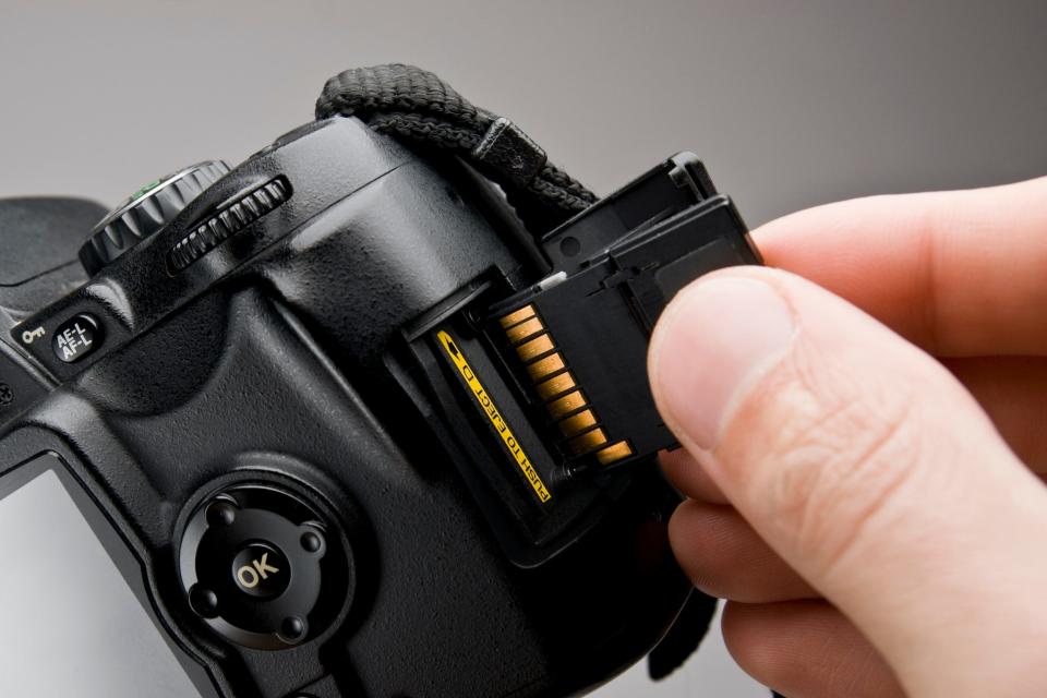 SD card being inserted into digital camera
