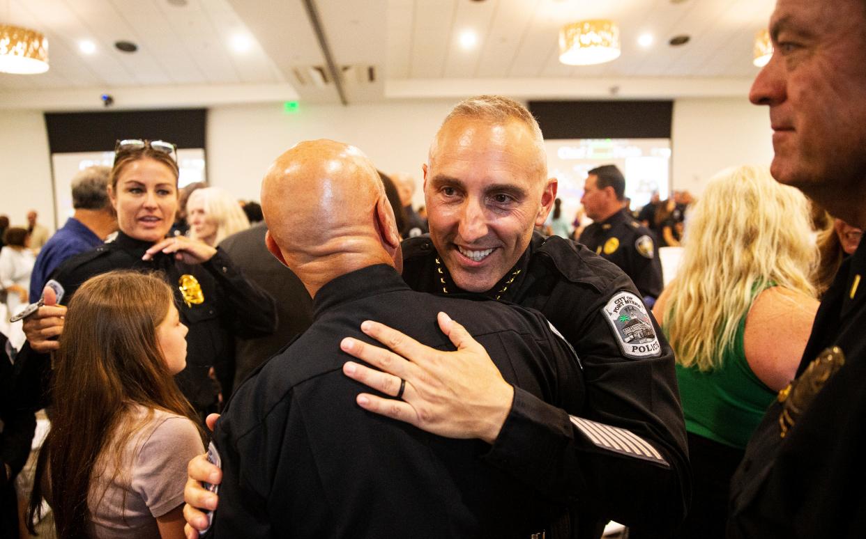 Newly sworn in Fort Myers Police Chief Jason Fields embraces Randall Pepitone at the Collaboratory on Wednesday August 2, 2023. Pepitone was the interim chief of police.