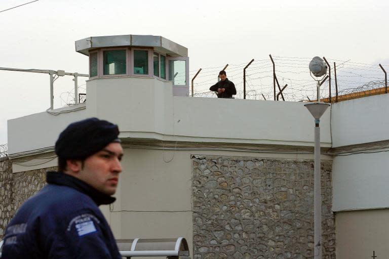 Police guard the area around the Korydallos prison, near Athens, after Greece's then most famous criminal, Vassilis Paleocostas, and an his Albanian accomplice, Alket Rizai, escaped by helicopter, on February 22, 2009