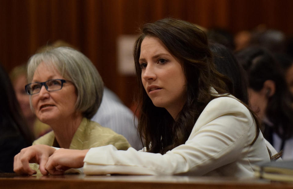 Sister of Oscar Pistorius, Aimee Pistorius, right, listens as her brother testifies in court in Pretoria, South Africa, Tuesday, April 8, 2014. Pistorius is charged with the murder of his girlfriend Reeva Steenkamp, on Valentines Day in 2013. (AP Photo/Masi Losi, Pool)