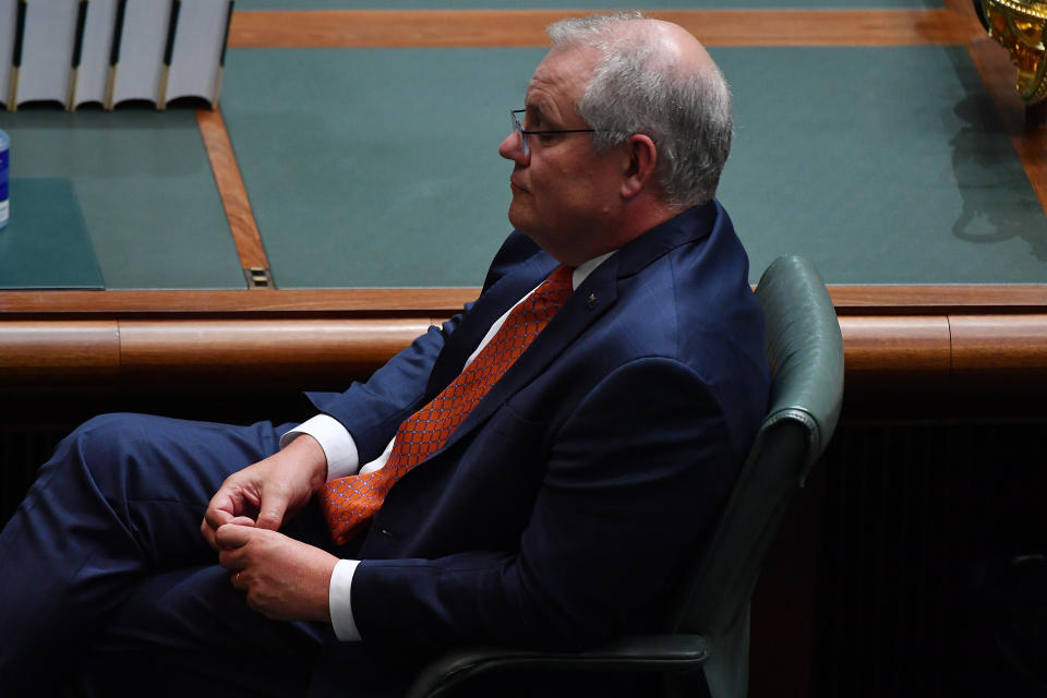 CANBERRA, AUSTRALIA - OCTOBER 08: Prime Minister Scott Morrison listens as Labor Opposition leader Anthony Albanese during his budget reply speech on October 08, 2020 in Canberra, Australia. The Morrison government's second budget was published on Tuesday after its release in May was delayed by the COVID-19 pandemic. Treasurer Josh Frydenberg has delivered a federal budget deficit of $213.7 billion in the wake of coronavirus and related shutdowns, with a number of tax cuts to be introduced to help boost the economy and create jobs as Australia experiences its first recession in 29 years. (Photo by Sam Mooy/Getty Images)