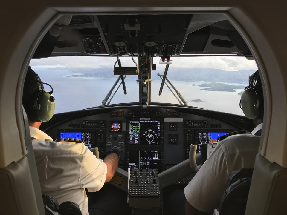 Pilot and co-pilot piloting aeroplane from airplane cockpit