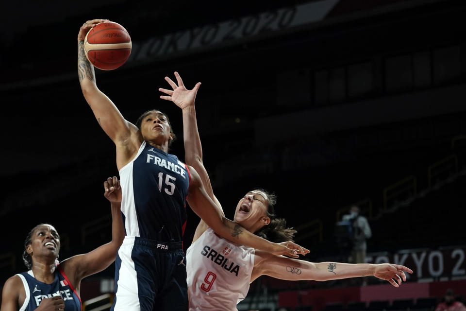 France's Gabrielle Williams (15) grabs a rebound over Serbia's Jelena Brooks (9) during the women's basketball bronze medal game at the 2020 Summer Olympics, Saturday, Aug. 7, 2021, in Saitama, Japan. (AP Photo/Charlie Neibergall)