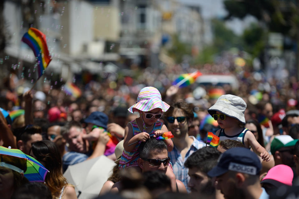 Kids are carried over the shoulders of their parents during the Annual Gay Pride parade in Tel Aviv on June 12, 2015. The parade, celebrated as part of Tel Aviv Pride Week events, attracted many thousands of participants from all over the world. (Photo by Gili Yaari/NurPhoto)