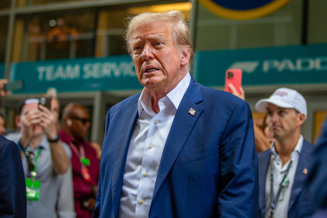 Former President Donald Trump, without a tie, attends a Formula 1 race in Miami.