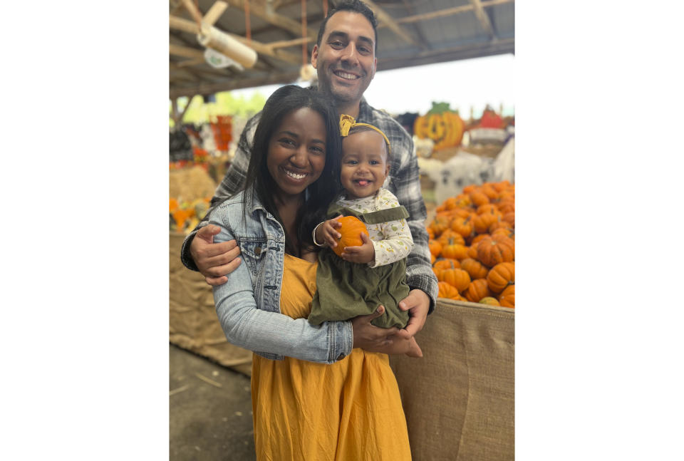 This photo shows Andy Giron with his wife, Alana Giron, and infant daughter in October 2022 in Melville, New York. Giron met his wife on the dating app Hinge and married six months later. (Hindy Giron via AP)