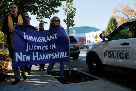 Demonstrators hold an "Interfaith Prayer Vigil for Immigrant Justice" outside the federal building, where ethnic Chinese Christians who fled Indonesia after wide scale rioting decades ago and overstayed their visas in the U.S. must check-in with ICE, in Manchester, New Hampshire, U.S., October 13, 2017. REUTERS/Brian Snyder