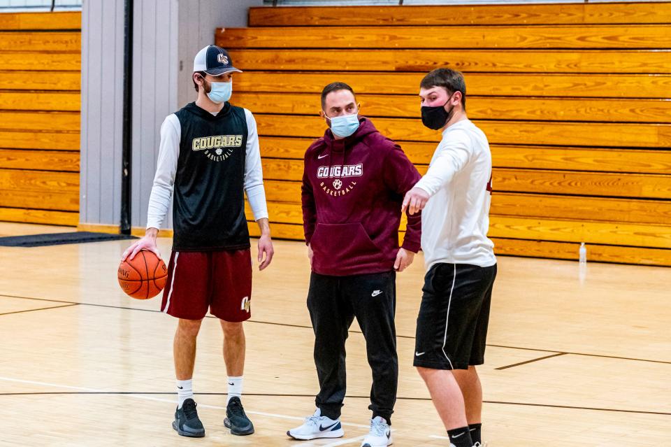 Old Colony's (L-R) Jake Jason, head coach Matt Trahan and Paul Soucy talk during practice.