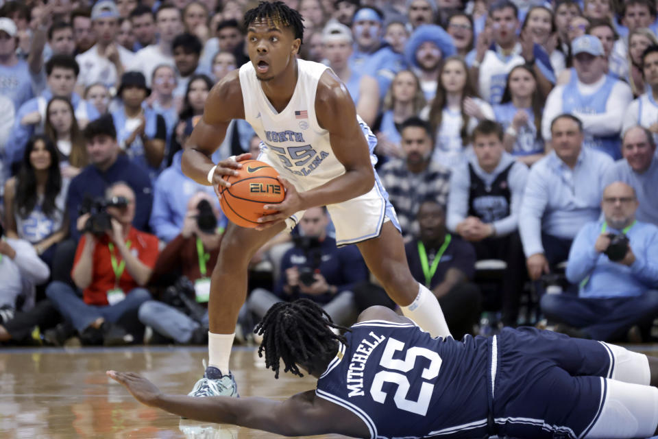 North Carolina forward Harrison Ingram (55) looks to pass over Duke forward Mark Mitchell (25) during the first half of an NCAA college basketball game Saturday, Feb. 3, 2024, in Chapel Hill, N.C. (AP Photo/Chris Seward)