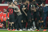 Leverkusen's head coach Xabi Alonso instructs Leverkusen's Alex Grimaldo after Leverkusen's Jeremie Frimpong scored his side's opening goal during the German soccer cup match between Bayer 04 Leverkusen and Fortuna Duesseldorf in Leverkusen, Germany, April 3, 2024. (AP Photo/Martin Meissner)
