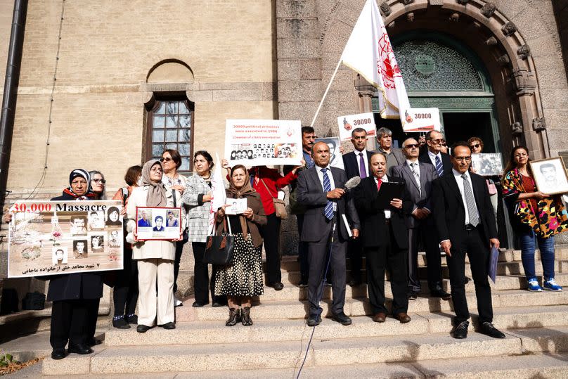 Supporters of the People's Mojahedin Organization of Iran protest outside Stockholm's district court on the first day of the trial of Hamid Noury, in Stockholm, August 2021. 