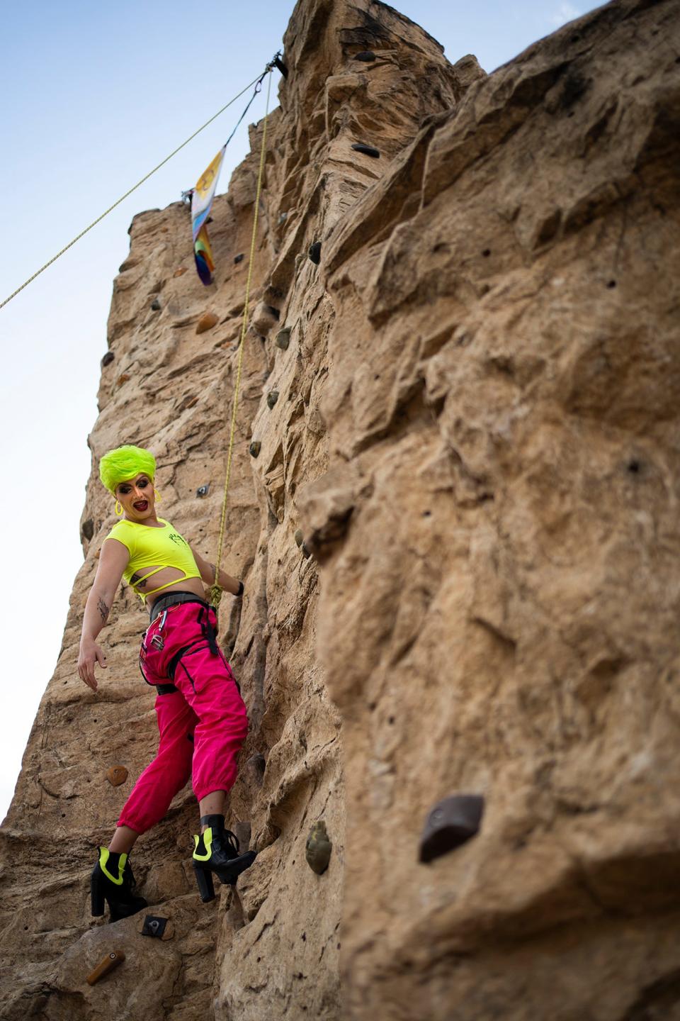 Drag queen Anaslaysia, Brit Bordner, of Olde Town East, climbs upward in heels during an event at the Audubon Climbing Wall hosted by Queer Climbing Columbus.