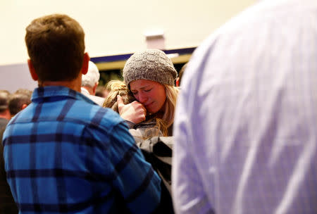 Mourners are seen at a vigil for families of victims of a mass shooting in Thousand Oaks, California, U.S. November 8, 2018. REUTERS/Eric Thayer