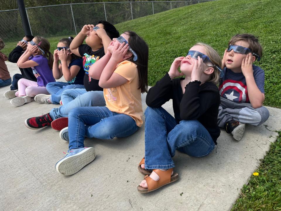 Teacher Amy Hertzske's Kindergarten class excitedly watches their first partial eclipse at Riverside Elementary School on April 8, 2023 in Columbia, Tenn.