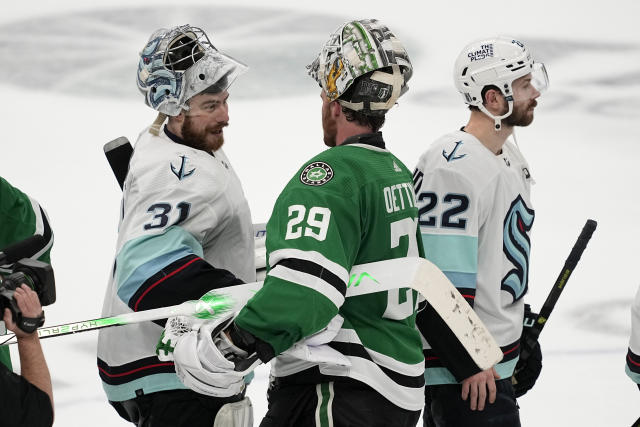 Seattle Kraken's Philipp Grubauer (31) and Dallas Stars' Jake Oettinger (29) shake hands after Game 7 of an NHL hockey Stanley Cup second-round playoff series, Monday, May 15, 2023, in Dallas. (AP Photo/Tony Gutierrez)