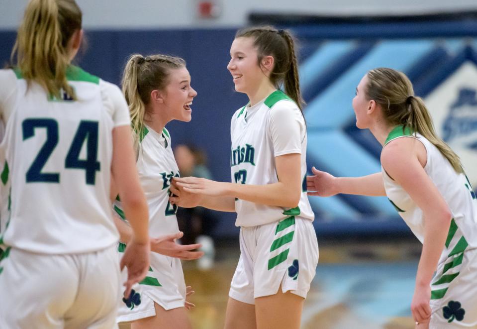 Teammates congratulate Peoria Notre Dame's Emy Wardle, middle, after drawing a foul on a successful layup against Rock Island-Alleman in the second half of their Class 2A girls basketball super-sectional Monday, Feb. 26, 2024 at Bureau Valley High School in Manlius. The Irish earned a berth in the state semifinals with a 55-39 win.