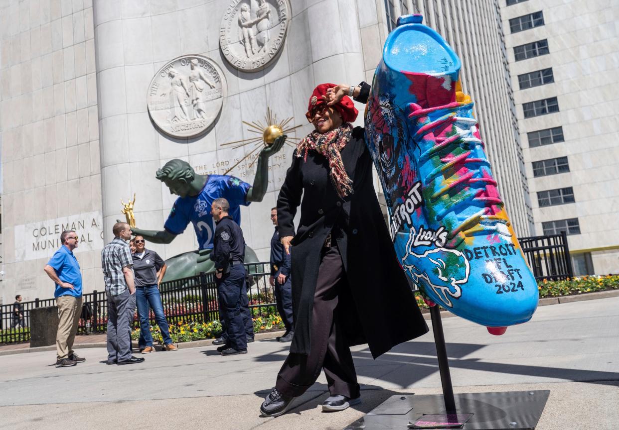 Yolanda Russell, of Detroit, makes her way through downtown Detroit while stopping to take selfies at all of the things related to the upcoming NFL draft on Tuesday, April 16, 2024, in downtown Detroit. u0022I'm absolutely thrilled though I'm generally not a sports person,u0022 said Russell, about the upcoming NFL draft being held in her hometown. Russell said the first time she ever watched the NFL draft was during the pandemic and loves what it means for the players and their families and support staff. u0022Now it's here in my own backyard. I love it.u0022