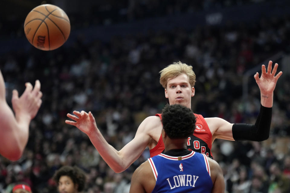 Toronto Raptors guard Gradey Dick, back, commits an offensive foul on Philadelphia 76ers guard Kyle Lowry during the first half of an NBA basketball game in Toronto, Sunday, March 31, 2024. (Frank Gunn/The Canadian Press via AP)