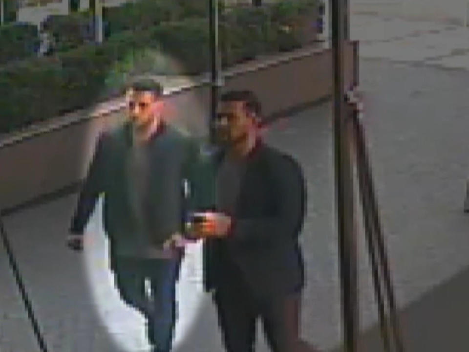 Joey Comunale, highlighted at left, and Larry Dilione are seen on surveillance video walking back into the Grand Sutton. / Credit: Prosecution trial evidence