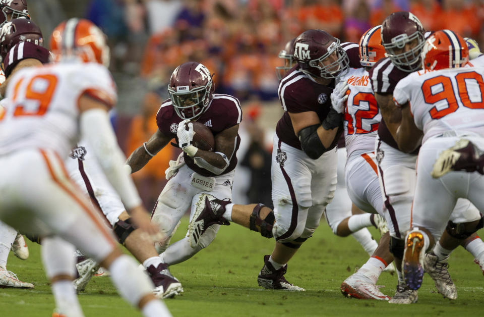 Texas A&M running back Trayveon Williams (5) rushes upfield against Clemson during the first quarter of an NCAA college football game Saturday, Sept. 8, 2018, in College Station, Texas. (AP Photo/Sam Craft)