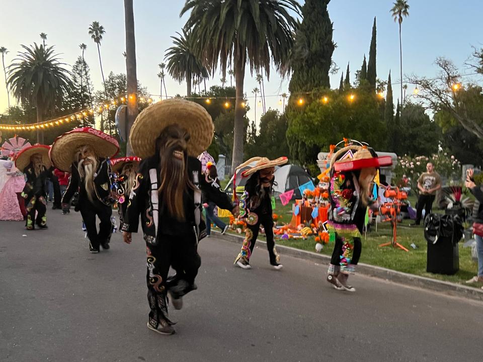 Masked dancers perform at the Día de Los Muertos celebration at the Hollywood Forever Cemetery in Los Angeles on Saturday, Oct. 28, 2023.