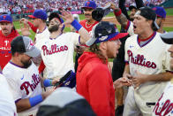 The Philadelphia Phillies celebrate a win over the Atlanta Braves after Game 4 of baseball's National League Division Series, Saturday, Oct. 15, 2022, in Philadelphia. The Philadelphia Phillies won, 8-3. (AP Photo/Matt Rourke)
