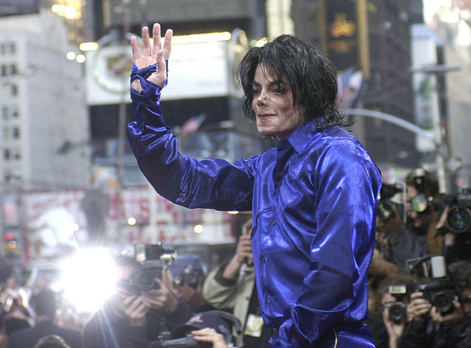 FILE - Nov. 7, 2001 file photo, Michael Jackson waves to crowds gathered to see him at his first ever in-store appearance to celebrate his new album "Invincible" in New York's Times Square.When Michael Jackson’s record label released his first posthumous album a year after he passed in 2010, producer Rodney Jerkins was asked to work on the project and he declined. Years later, the hitmaker, who worked heavily on Jackson’s 2001 comeback album “Invincible," says he now feels comfortable producing Jackson music after the King of Pop suddenly died in 2009. He produced the title track from the upcoming album, “Xscape,” out May 13, 2014. (AP Photo/Suzanne Plunkett, file)