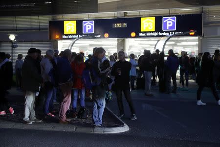 People stand outside at Landvetter Airport, which is evacuated after a bag was left near the information desk at the airport outside Gothenburg, Sweden, May 22, 2017. TT News Agency/Adam Ihse/via REUTERS